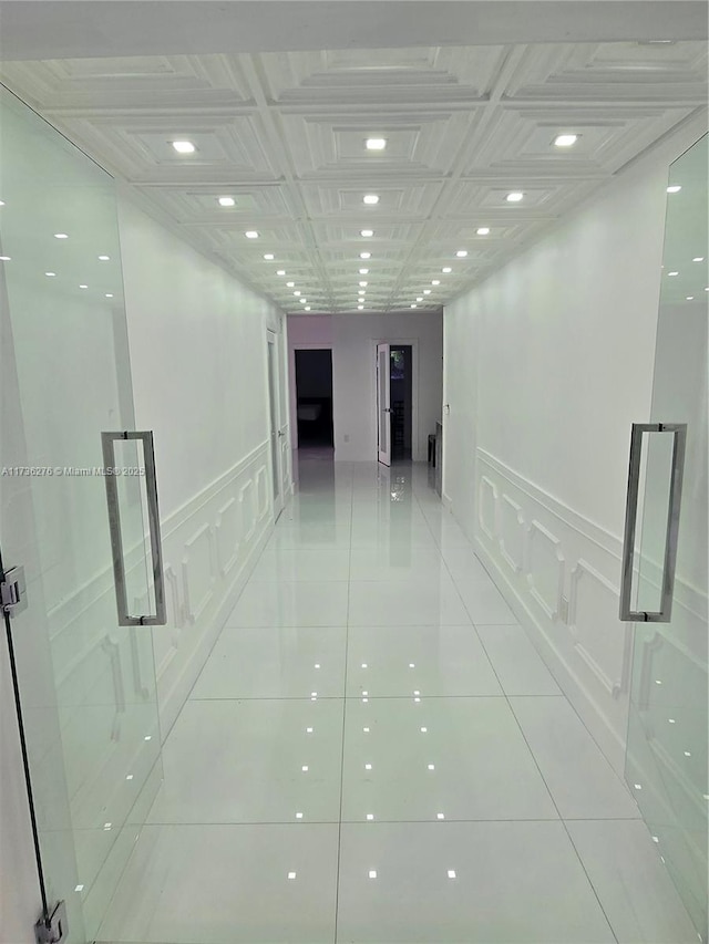 hall with light tile patterned floors