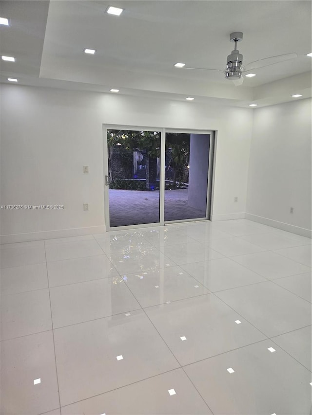 tiled empty room with ceiling fan