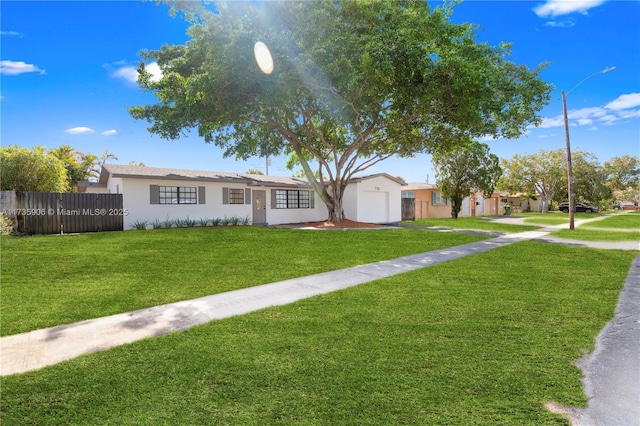 ranch-style home with a front lawn and a garage