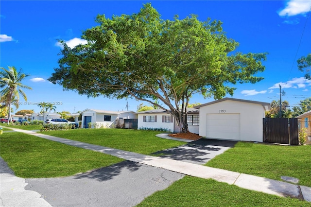 ranch-style home with a garage and a front lawn