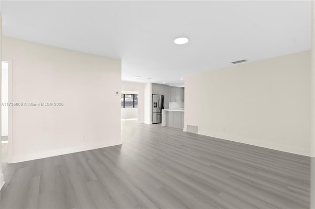 unfurnished living room with light hardwood / wood-style floors