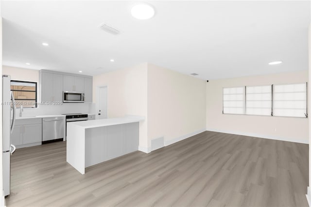 kitchen featuring light hardwood / wood-style flooring and appliances with stainless steel finishes