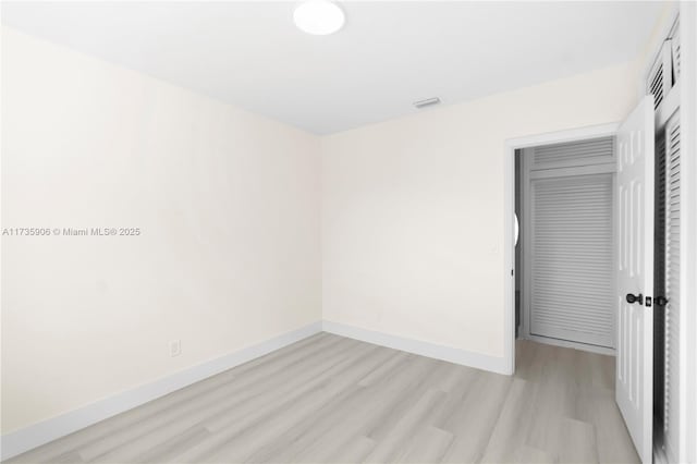 unfurnished bedroom featuring light hardwood / wood-style floors and a closet