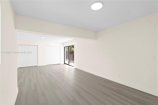 unfurnished room with light wood-type flooring