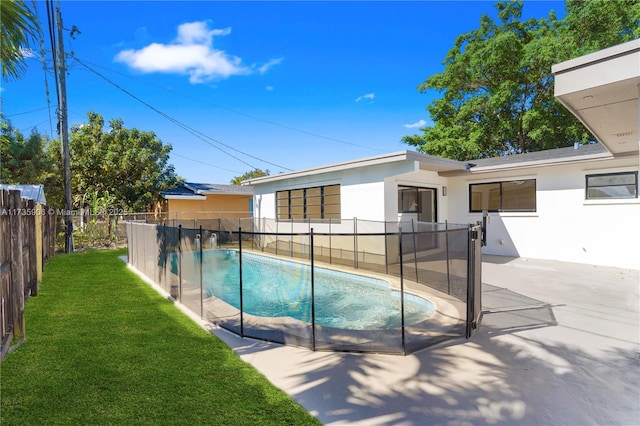 view of pool featuring a yard and a patio