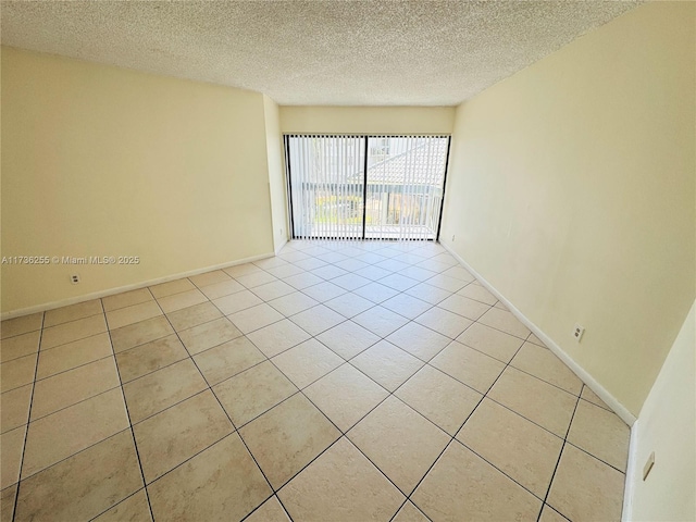1880 N Congress Ave Unit 210, West Palm Beach, FL 33401 - empty room with light tile patterned flooring, a textured ceiling, and baseboards