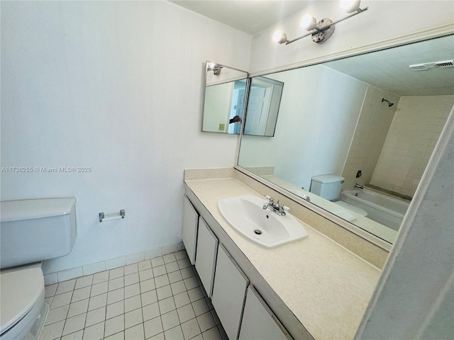 full bathroom featuring vanity, tiled shower / bath, tile patterned floors, and toilet