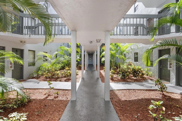 view of exterior entry with a balcony