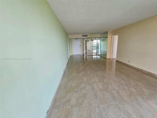 empty room featuring a textured ceiling