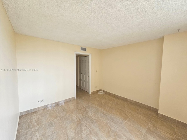 empty room featuring a textured ceiling