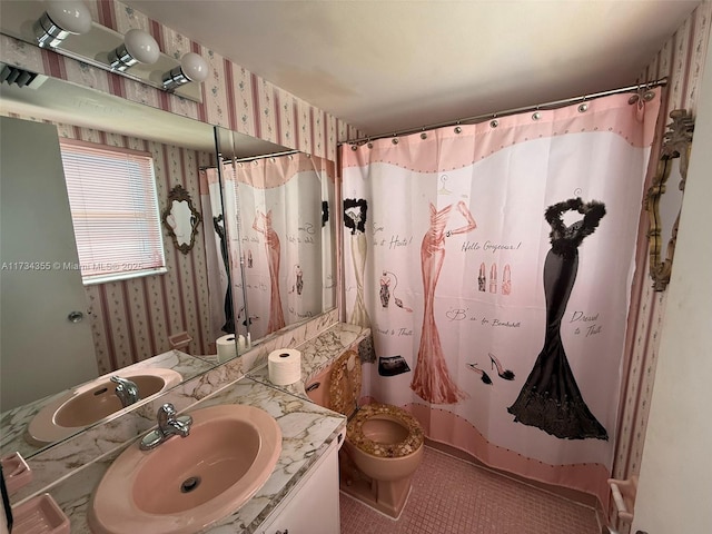 bathroom with vanity, tile patterned flooring, curtained shower, and toilet