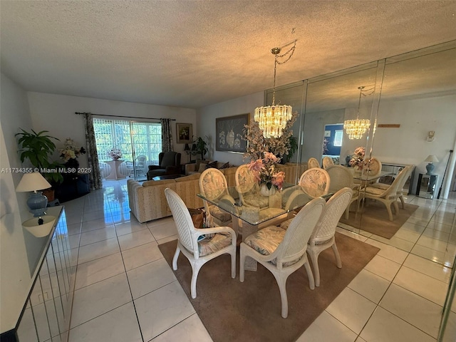 tiled dining area featuring a notable chandelier and a textured ceiling