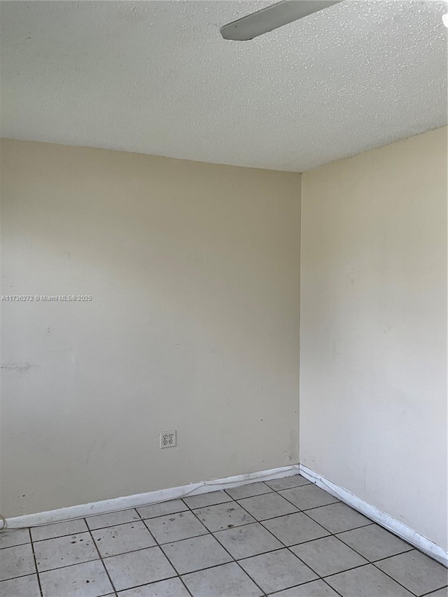 unfurnished room featuring a textured ceiling