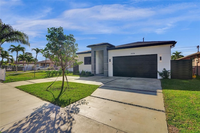 view of front of property featuring a garage and a front yard