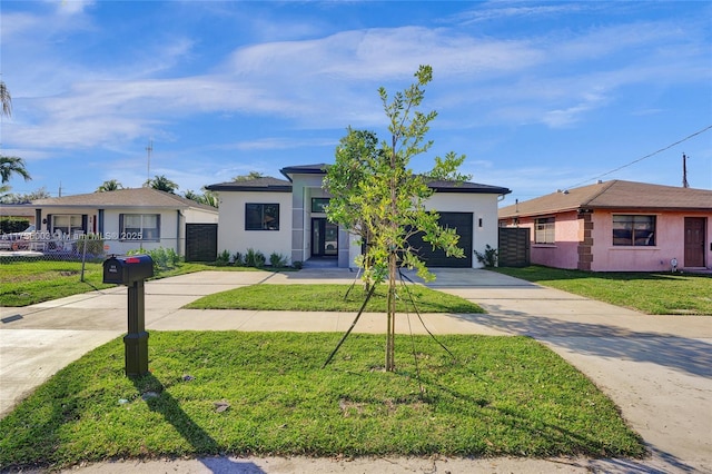 single story home with a garage and a front lawn