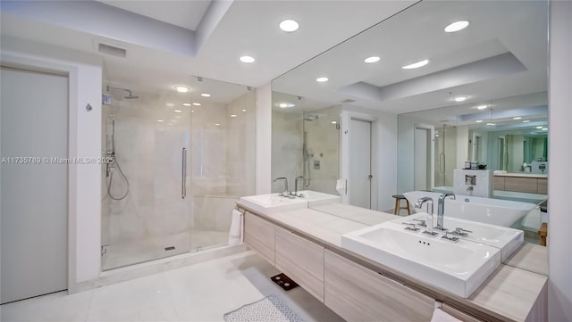 bathroom featuring vanity, a tray ceiling, an enclosed shower, and tile patterned flooring