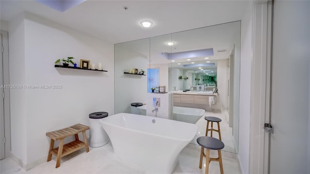 bathroom featuring a washtub and vanity