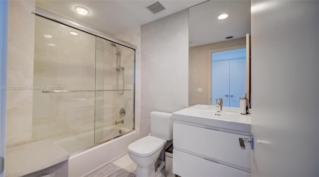 full bathroom featuring enclosed tub / shower combo, vanity, and toilet