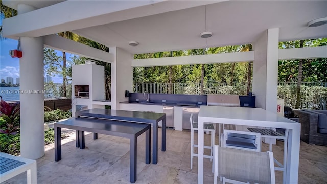 view of patio / terrace featuring sink and a fireplace