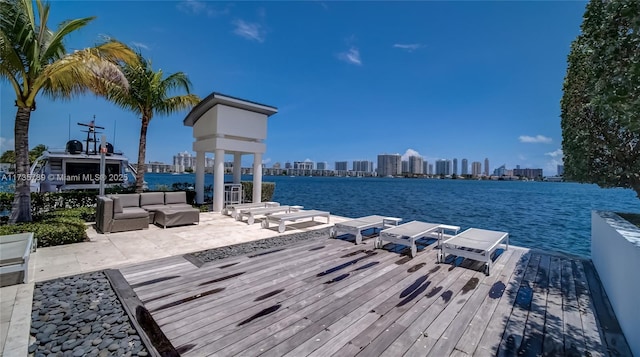 dock area featuring a deck with water view and an outdoor hangout area