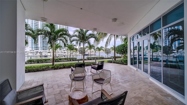 view of patio featuring a water view and french doors