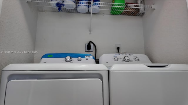 washroom with washing machine and clothes dryer