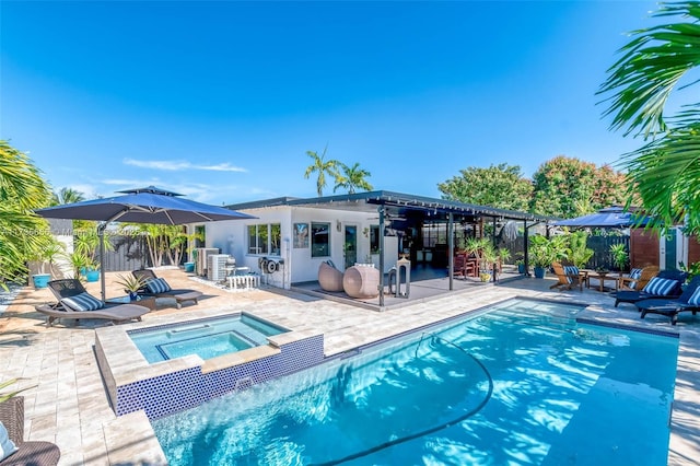 view of swimming pool with an in ground hot tub, an outdoor bar, and a patio area