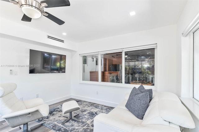 living room with hardwood / wood-style floors and ceiling fan