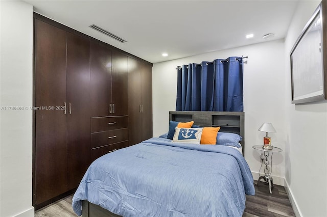 bedroom with hardwood / wood-style floors