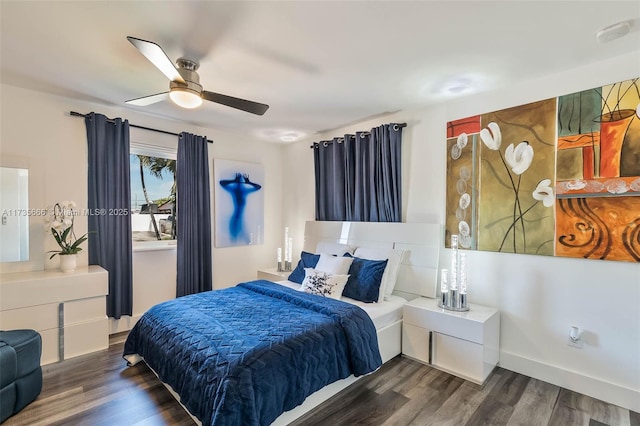 bedroom with ceiling fan and dark hardwood / wood-style flooring