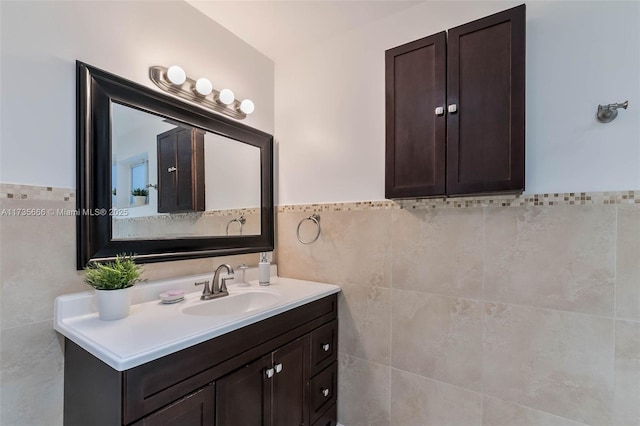 bathroom featuring tile walls and vanity