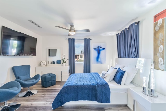 bedroom with hardwood / wood-style flooring and ceiling fan