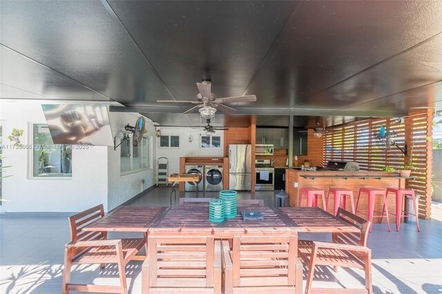 view of patio / terrace with a fenced in pool and ceiling fan