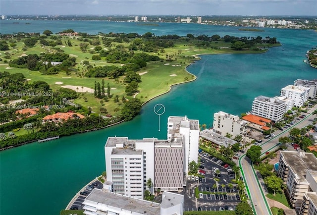 birds eye view of property with view of golf course, a water view, and a city view