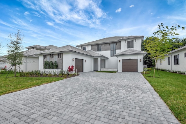 view of front of house with a garage and a front lawn