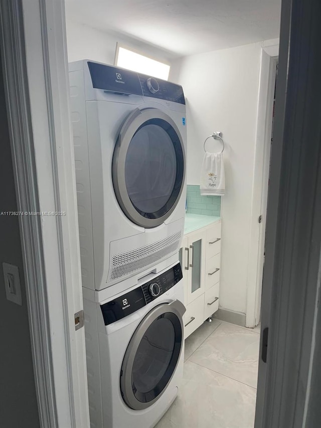 laundry room with stacked washer / drying machine