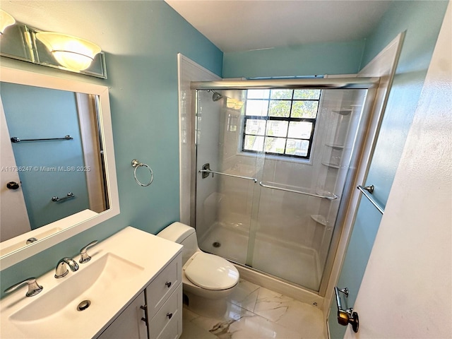 bathroom featuring walk in shower, vanity, and toilet