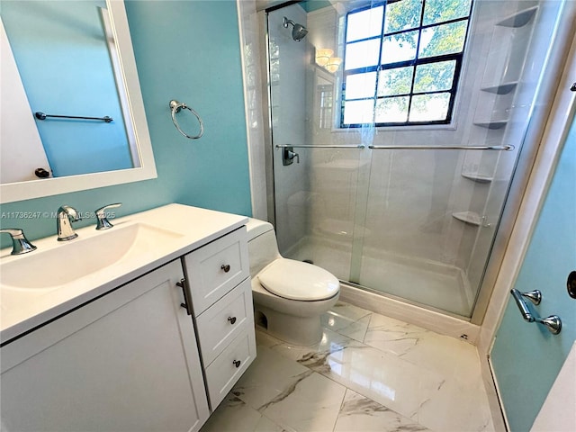 bathroom featuring vanity, an enclosed shower, and toilet