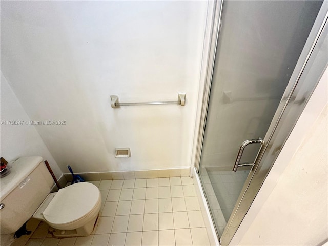 bathroom with tile patterned floors, toilet, and walk in shower