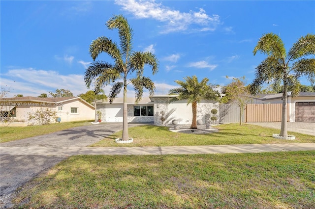 ranch-style house with a garage and a front yard