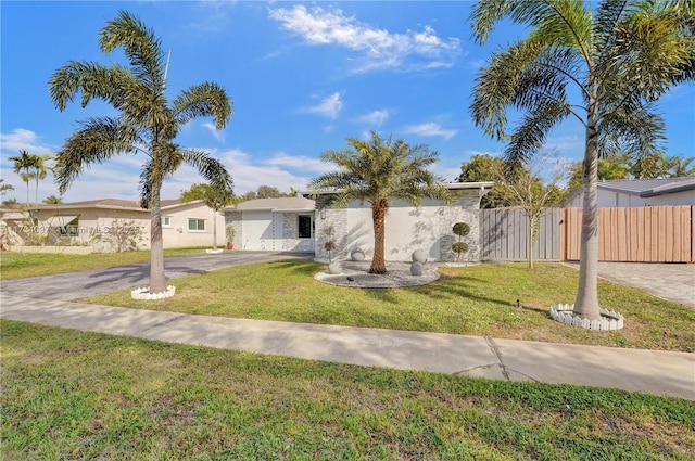 view of front of property with a garage and a front yard