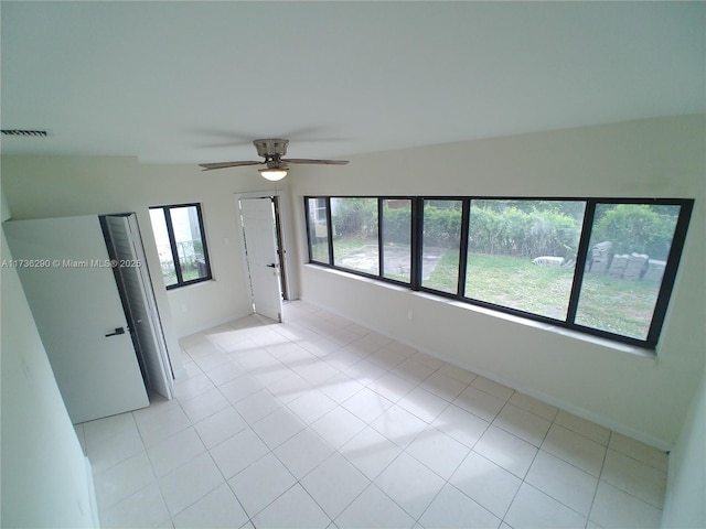 spare room featuring plenty of natural light and ceiling fan