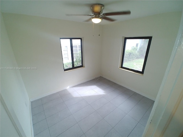 empty room with light tile patterned floors and ceiling fan