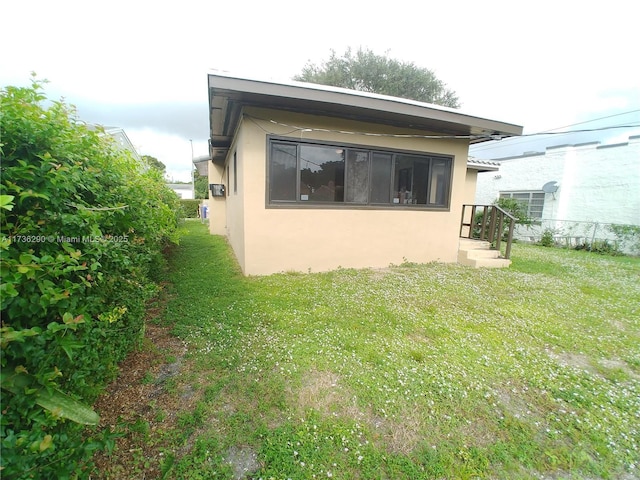 view of home's exterior with a lawn