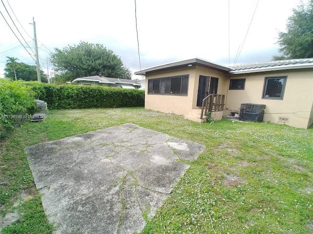 view of yard featuring a patio area and central air condition unit