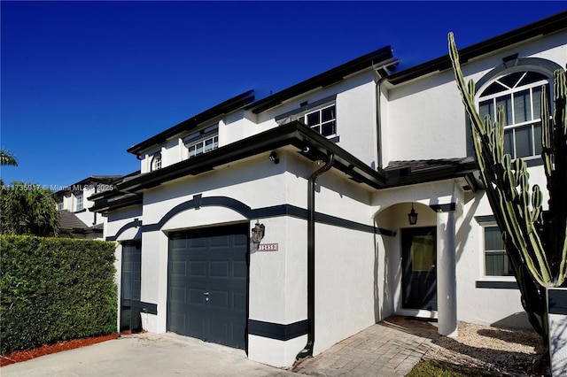 exterior space featuring a garage and stucco siding