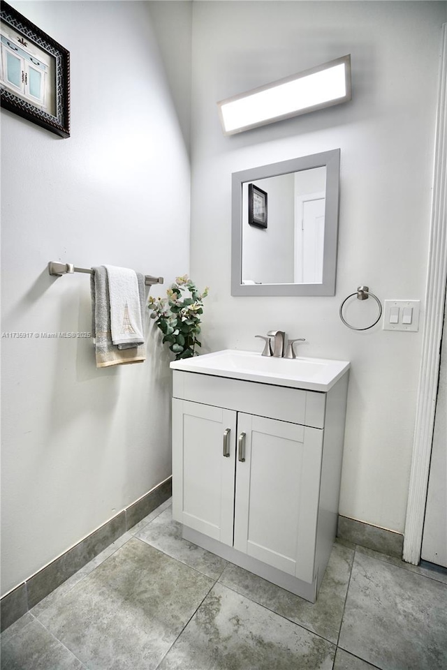 bathroom with baseboards and vanity