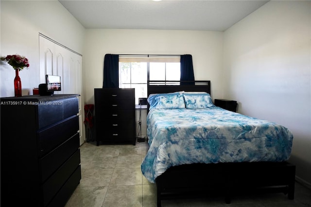 bedroom with light tile patterned floors