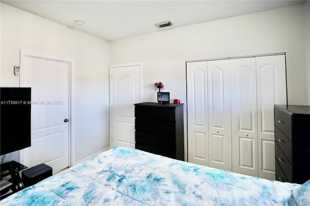 bedroom with a closet and visible vents