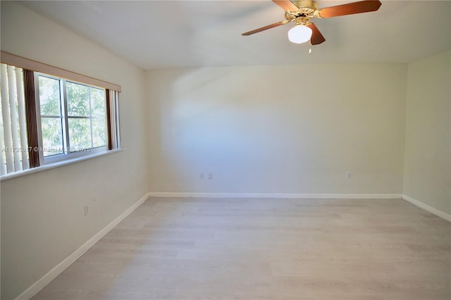 spare room with light wood-style flooring and baseboards